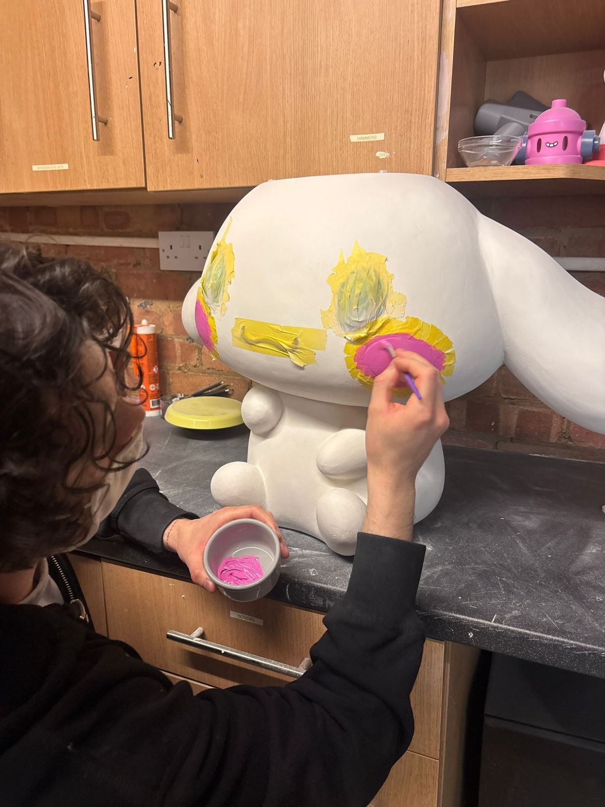 Radek hand-painting details on a Cinnamoroll sculpture