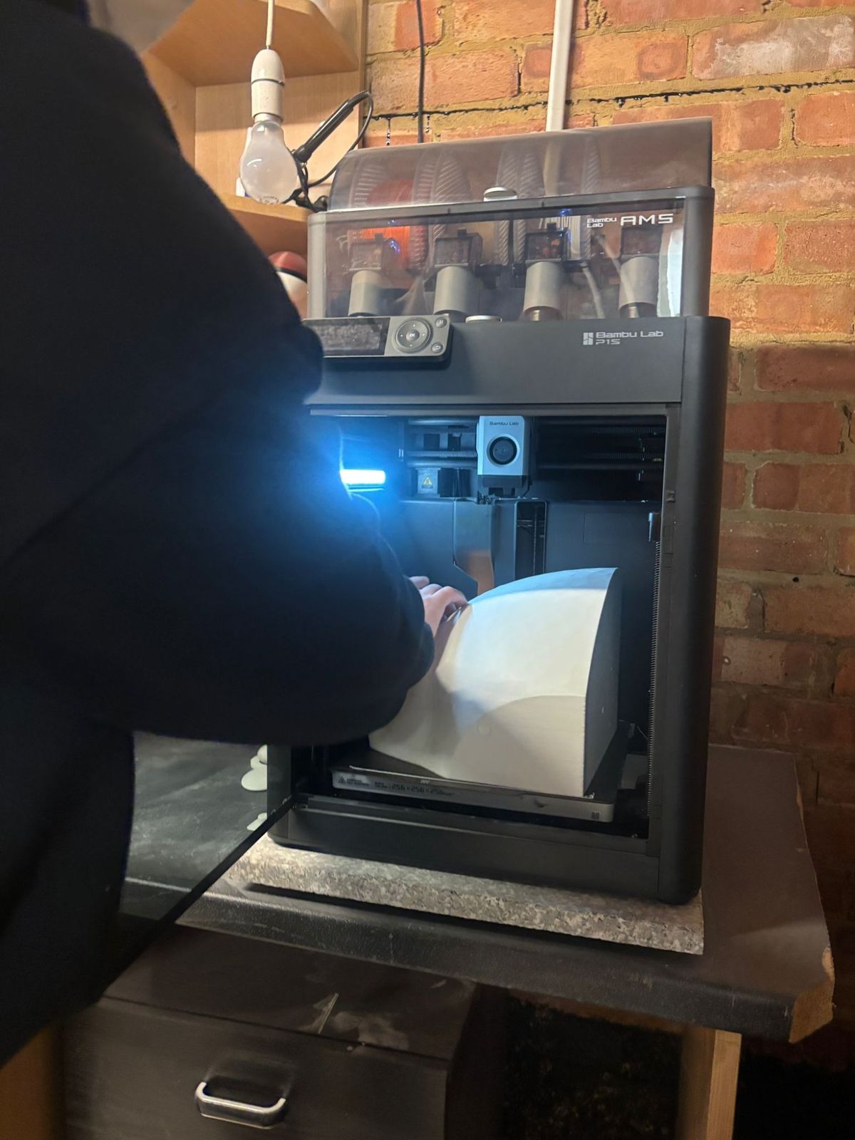 Bambu Lab P1S printer with a large 3D printed part being removed